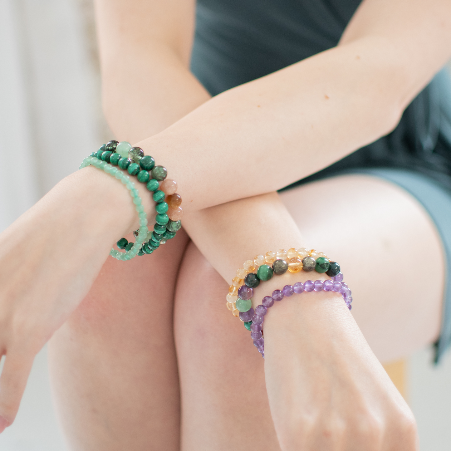 Close-up of a person wearing two beaded bracelets on their wrist.