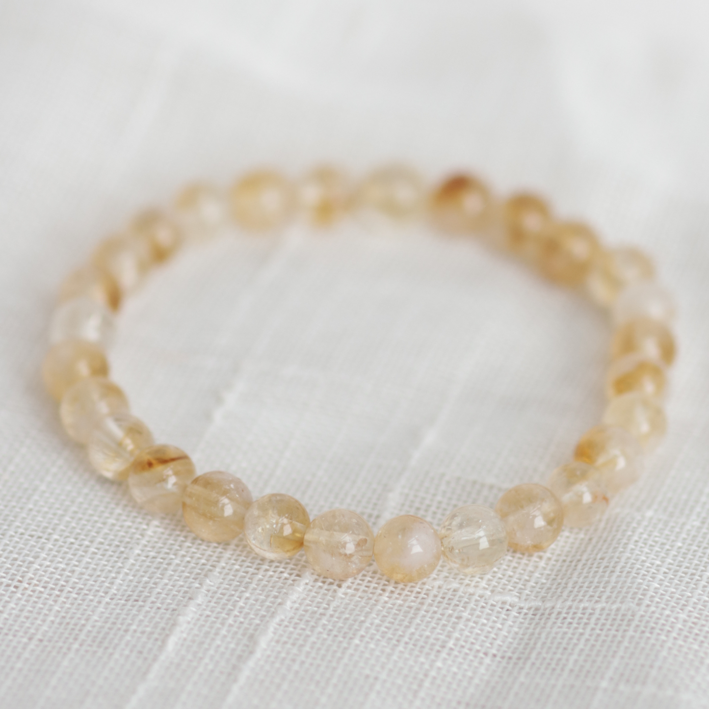 Beaded bracelet on a white fabric background