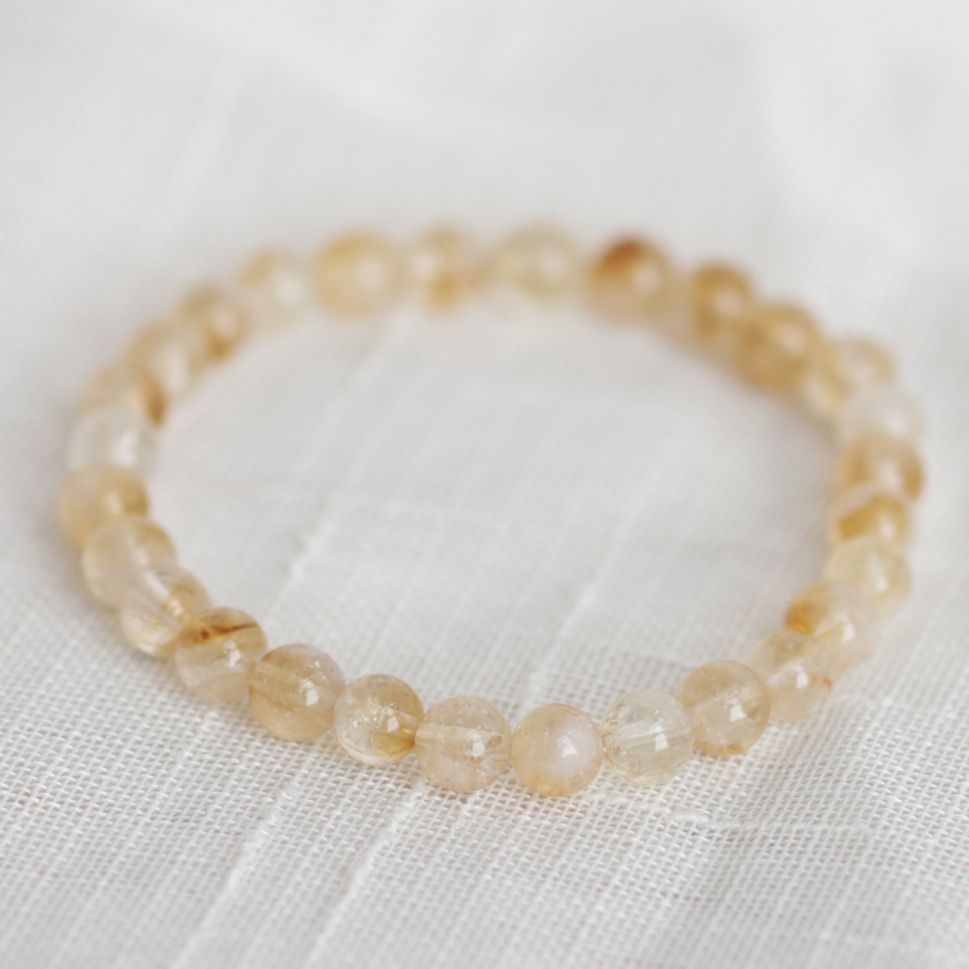 Beaded bracelet on a white fabric background